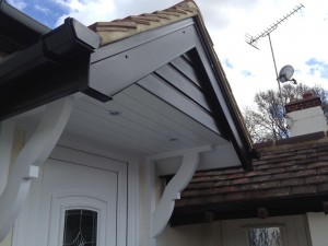 gallows brackets attached to a door canopy