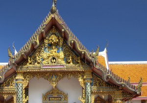Buddhist temple in Southeast Asia with ornate, detailed barge boards