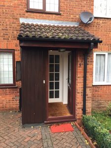 Old porch roof with incorrect pitch and rotten timber