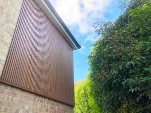 Spiced oak slatted cladding installation in Caterham