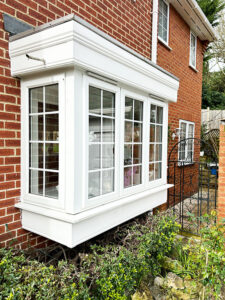 Ornate white fascias over a bay window