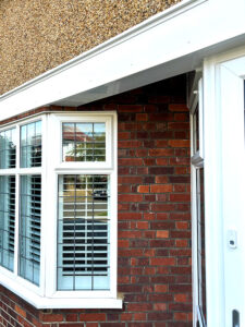 Replacement white uPVC bargeboards over bay window