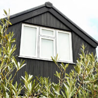 Composite black slatted cladding at rear of property in Surrey