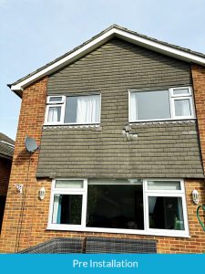 Damaged hanging tiles before installation of new cladding