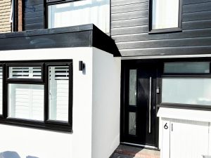 Black cladding installation around front door in Loughton, Essex