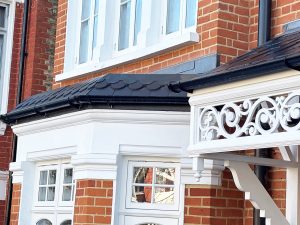 Door canopy detailing with fleur-de-lis design around the edge